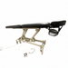 Side angled profile view of the black 2-section electric height control facial massage treatment table laid fully flat, showcasing its sturdy white steel lifting frame and sleek cushioning.