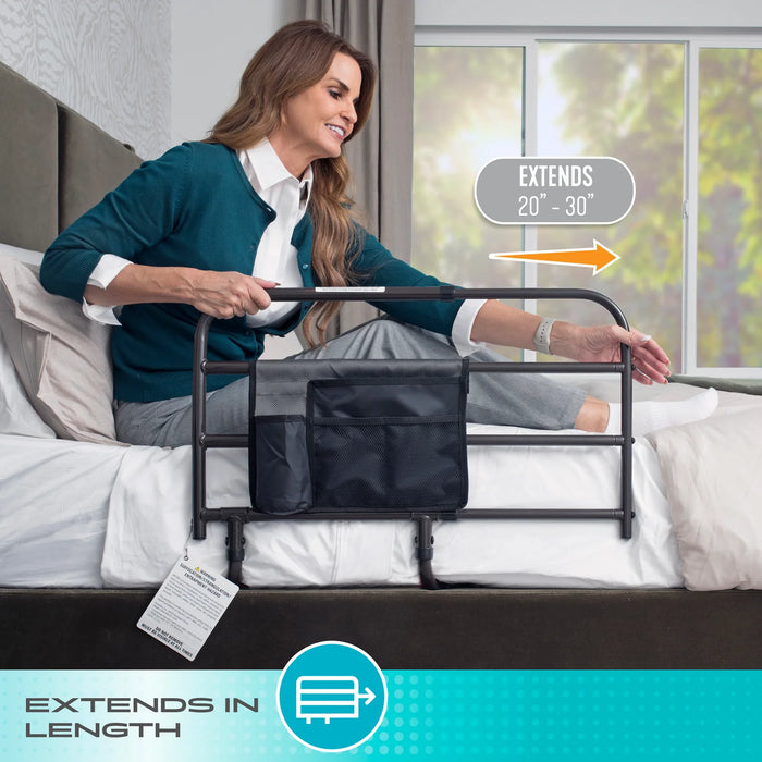 Wonder Bar bed rail model 8000 highlighting the extends in length feature from 20 to 30 inches, woman adjusting the rail while sitting on a bed, from Therapy Supply