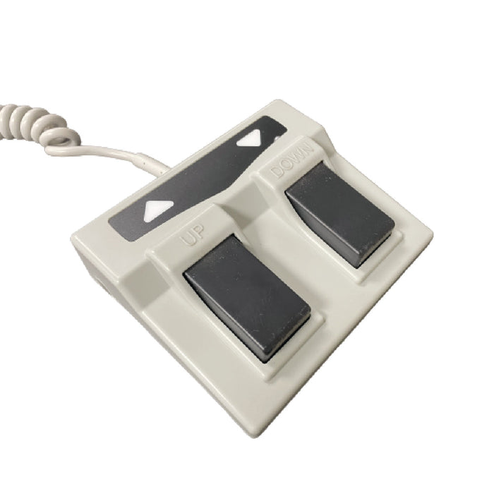 Close-up view of the dual electric foot pedal controls for the A-Lek massage table, allowing practitioners hands-free, smooth height adjustments during therapy sessions.