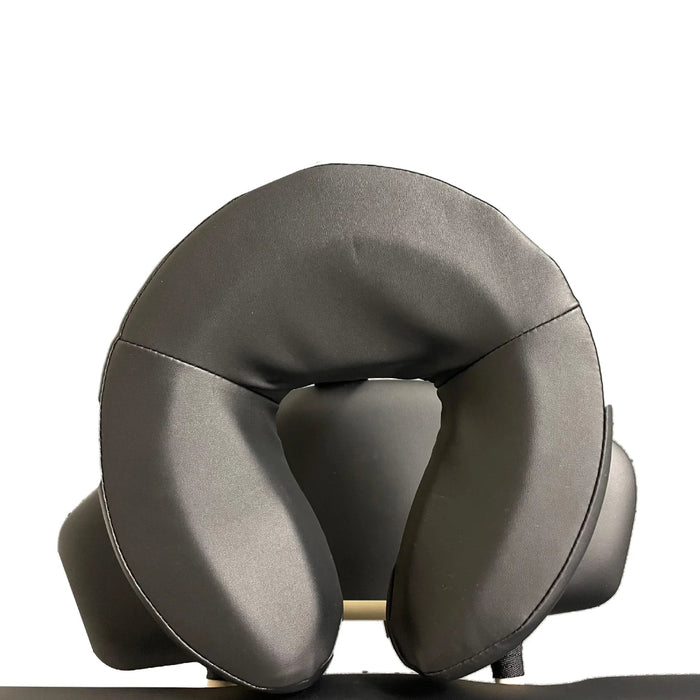 Close-up detail of the ergonomic black contoured headrest cushion included with the A-Lek flat top electric massage table for optimal patient comfort.