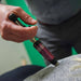 A lifestyle image showing the ACTIVATOR IV being used for a clinical back adjustment, demonstrating its use on tender areas of the body.