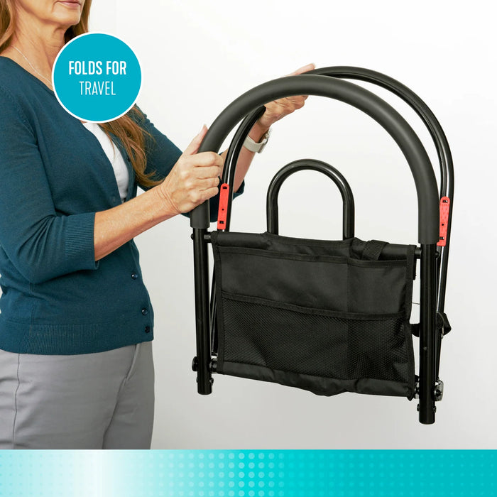 Bed assist rail model 5000 highlighting the folds for travel feature, person folding the black metal rail with attached storage pouch, from Therapy Supply