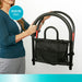 Bed assist rail model 5000 highlighting the folds for travel feature, person folding the black metal rail with attached storage pouch, from Therapy Supply