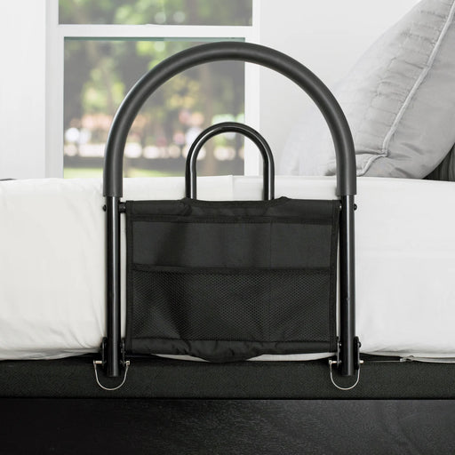 Bed assist rail model 5000 main product image showing the black metal safety rail with attached storage pouch attached to a white bed, from Therapy Supply