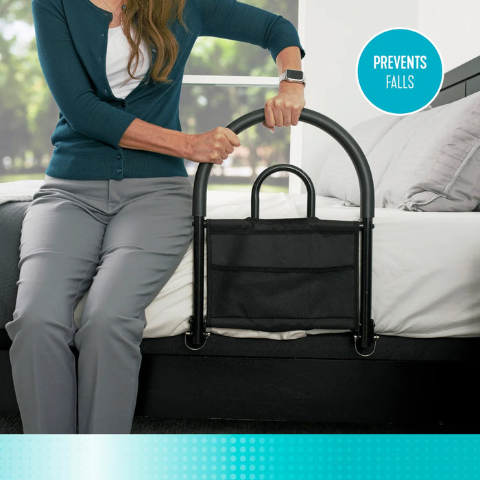 Bed assist rail model 5000 highlighting the prevents falls feature, woman using the black metal rail with attached storage pouch to get up from bed, from Therapy Supply