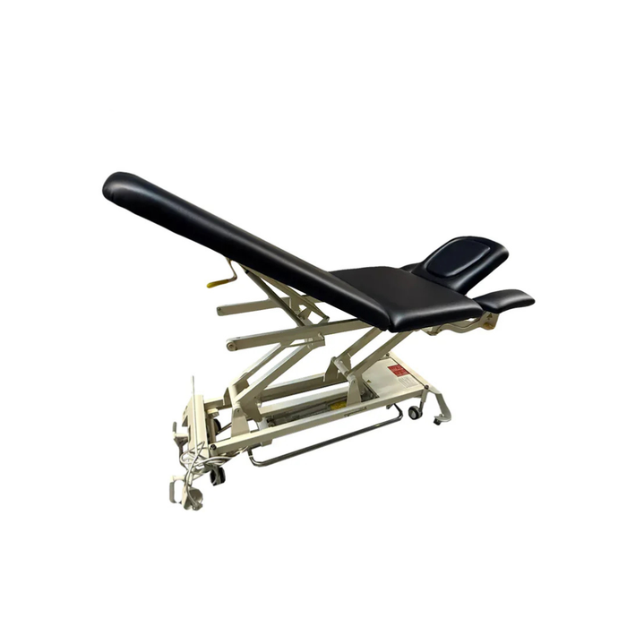 Black upholstered electric hi-lo treatment table with tilting backrest and face cradle, shown in raised position with hydraulic base, from Therapy Supply