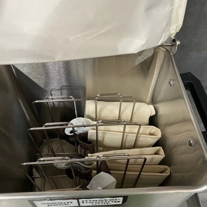 A detailed view into the heating tank showing the standard size moist heat packs being heated in the clinical-grade water bath.