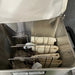 A detailed view into the heating tank showing the standard size moist heat packs being heated in the clinical-grade water bath.