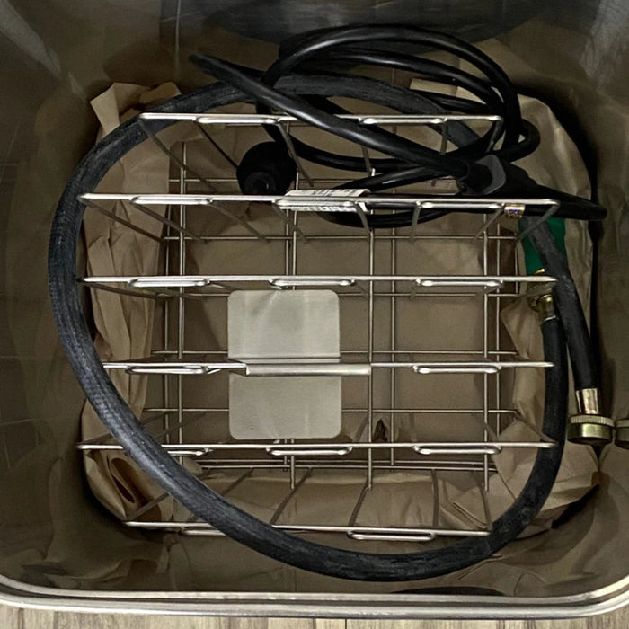 A technical view of the internal storage rack and the set of six moist heat packs included with the E2 unit for professional treatment environments.