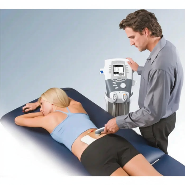 A professional therapist applying the Intelect Legend XT electrotherapy system to a patient in a clinical setting, demonstrating its use for targeted muscle stimulation.