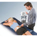 A professional therapist applying the Intelect Legend XT electrotherapy system to a patient in a clinical setting, demonstrating its use for targeted muscle stimulation.