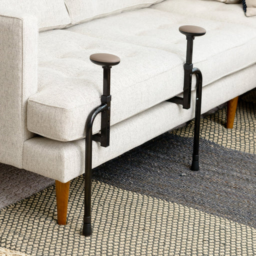 Couch cane stand assist model 2200 main product close-up showing the black metal frame with two padded grip pads attached to a beige sofa, from Therapy Supply