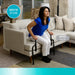 Couch cane stand assist model 2200 in use by woman rising from a beige sofa, showing safely sit or stand and supports 300 lbs features, from Therapy Supply