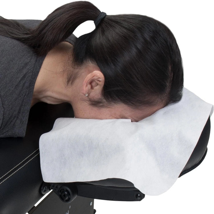 A lifestyle image of a client in the prone position using a disposable face rest cover, showcasing the comfortable fiber against the skin.