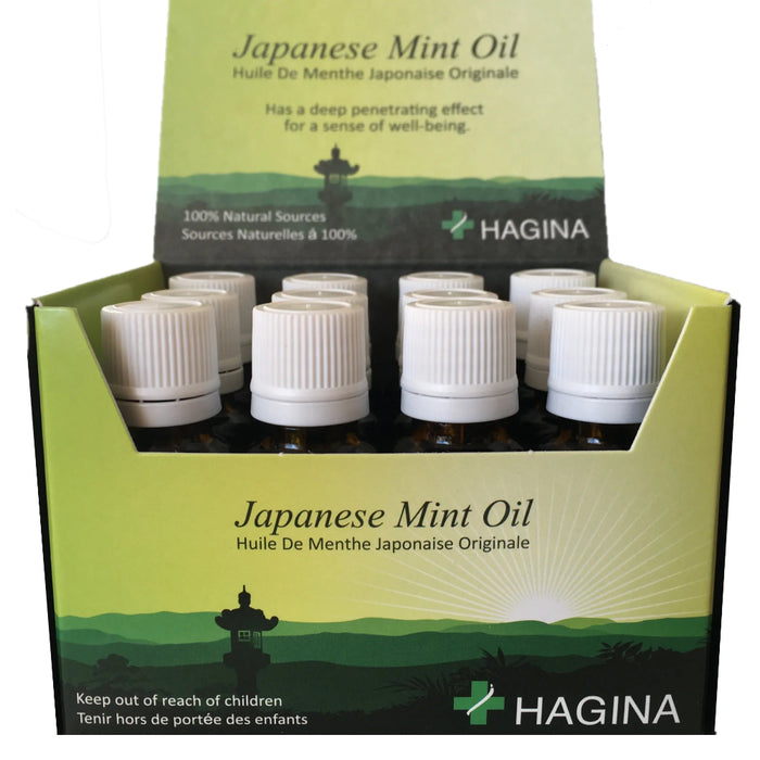 An open display box of HAGINA Japanese Mint Oil bottles, highlighting its use by professional therapists for stimulating circulation and relieving muscle cramps.