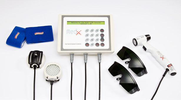 Med-X Rehab Console multi-modality therapy device with attachments including LED light therapy pad, ultrasound applicator, cold laser handpiece, protective glasses, and electrode pads, from Therapy Supply
