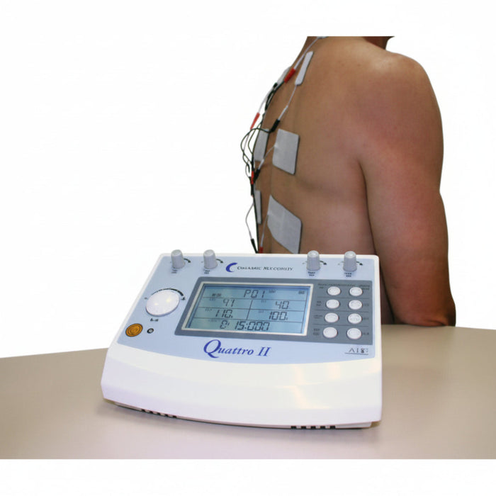 A lifestyle image showing the Quattro 2.5 being used for a clinical back treatment, illustrating the application of electrodes for targeted electrical stimulation.