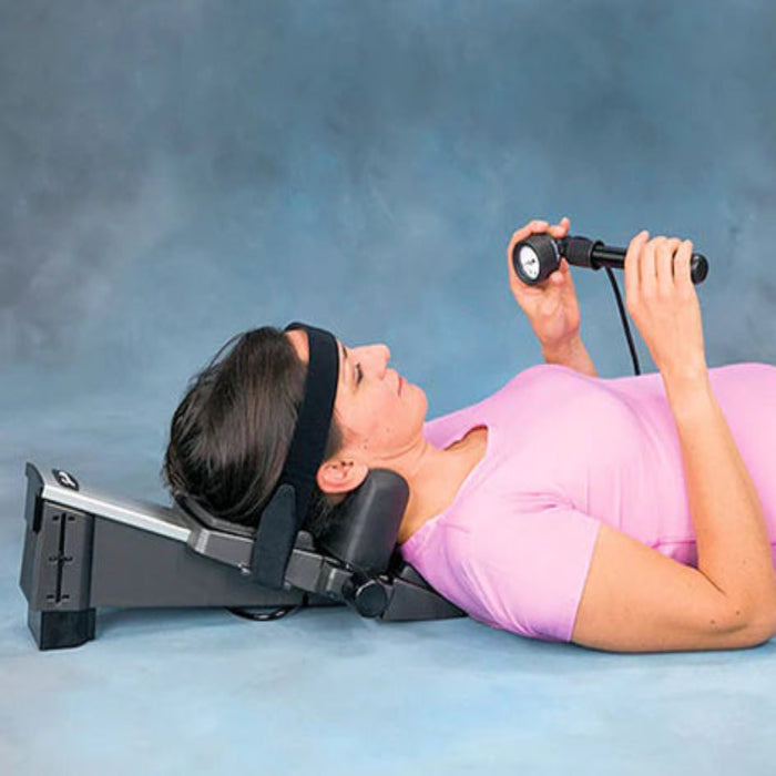 A close-up lifestyle view of a user securing the head strap on the Saunders device, showcasing the easy-to-manage format for independent use.