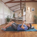 An overhead lifestyle shot of a user during a traction session, highlighting the comfort and proper spinal alignment provided by the device.