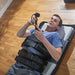 An overhead view of a user undergoing a lumbar traction session at home, illustrating the comfort and secure fit of the clinical-grade device.