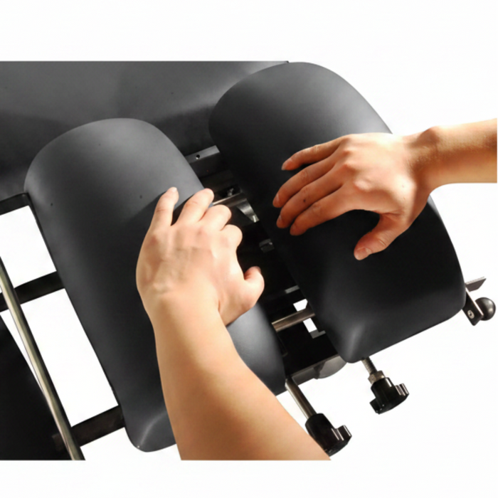 A lifestyle image demonstrating a practitioner performing a manual adjustment on the Series 260 table, highlighting its functional reliability.