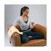 A user in a seated position applying the moist heating pad to their arm for relief from muscle spasms and tension.