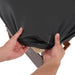 A practitioner securing the universal fitted cover over a massage table, illustrating the straightforward setup for daily clinic hygiene.