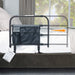 Wonder Bar bed rail model 8000 main product image showing the black metal rail with extending arm and attached storage pouch attached to a bed, from Therapy Supply