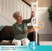 Wonder Pole model 1100 highlighting the handles rotate and lock every 45 degrees feature, senior woman seated on couch adjusting the white support pole handles, from Therapy Supply