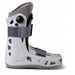 Side profile view of the Aircast AirSelect Short Walking Boot, highlighting its durable shell and rocker sole design that helps promote a natural gait during the recovery process.