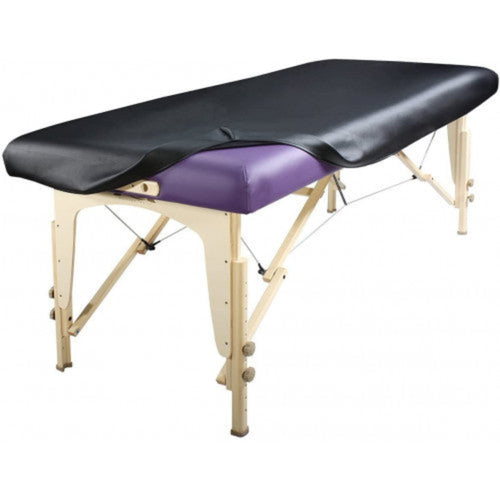 Full angled view of a portable massage table completely protected by the sleek, black Universal Fitted PU Vinyl Cover, ready for clinical or spa use.