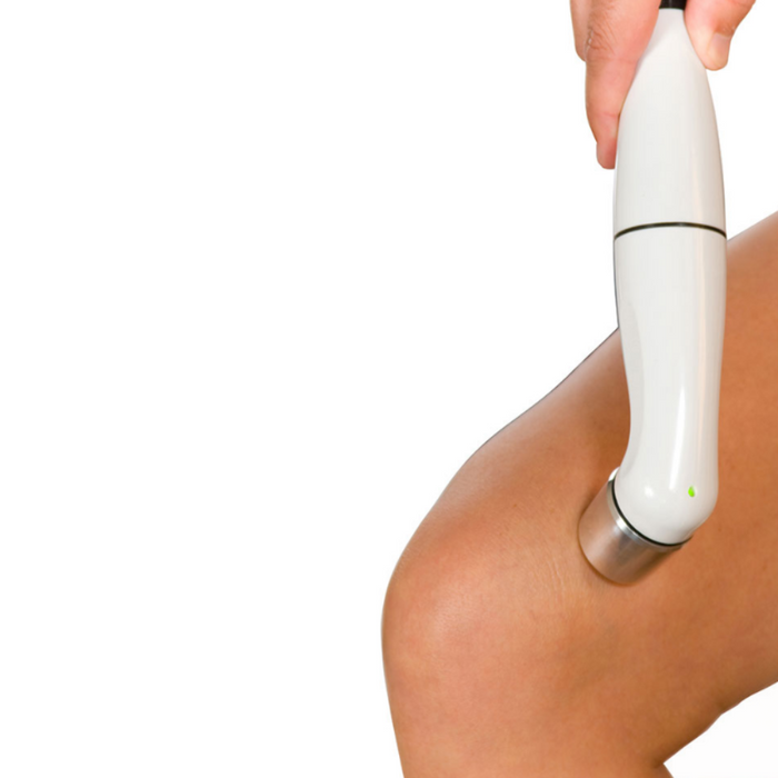 Close-up action shot demonstrating the dual-frequency 5 cm2 ultrasound head of the ComboCare device being applied to a patient's shoulder during a professional therapy session.