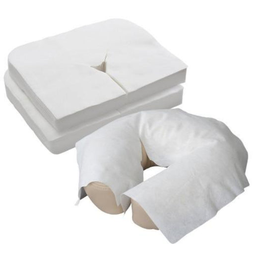 Stack of flat white Luxurious Disposable Face Cradle Covers displayed next to one soft, medical-grade fiber cover smoothly fitted over a U-shaped massage table face rest cushion.