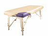 Angled view of a portable massage table fitted with the PU Vinyl Protection Cover in a light tan colorway, protecting the underlying upholstery from oils and spills.